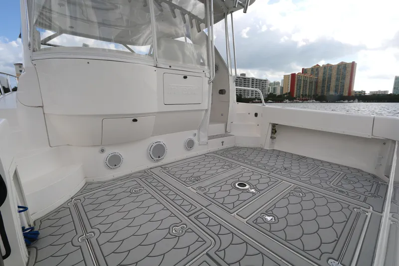  Yacht Photos Pics 2012 Intrepid 475 Sport Yacht deck with patterned flooring and cityscape background.