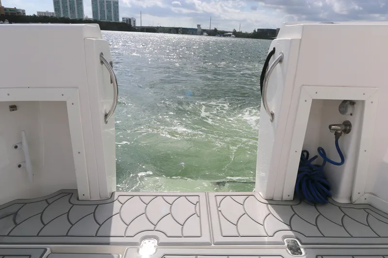  Yacht Photos Pics Stern view of 2012 Intrepid 475 Sport Yacht on water, featuring deck and ocean backdrop.