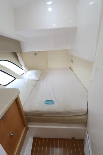  Yacht Photos Pics Interior cabin of 2012 Intrepid 475 Sport Yacht with bed and wooden flooring.