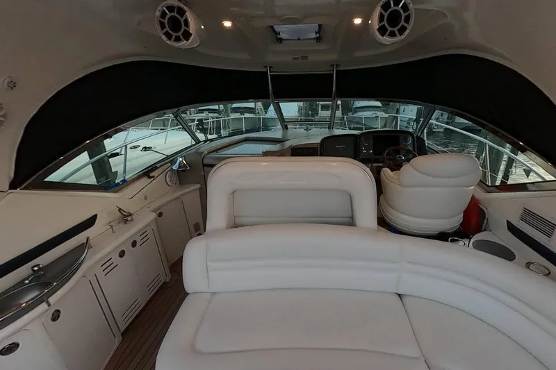  Yacht Photos Pics Interior of 2006 Sea Ray 44 Sundancer yacht with white seating and helm.
