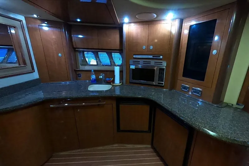  Yacht Photos Pics Luxurious kitchen interior of 2006 Sea Ray 44 Sundancer yacht with modern amenities.