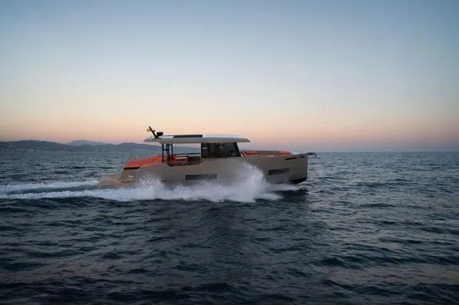  Yacht Photos Pics 2025 De Antonio Yachts D50 cruising at sunset on open water.