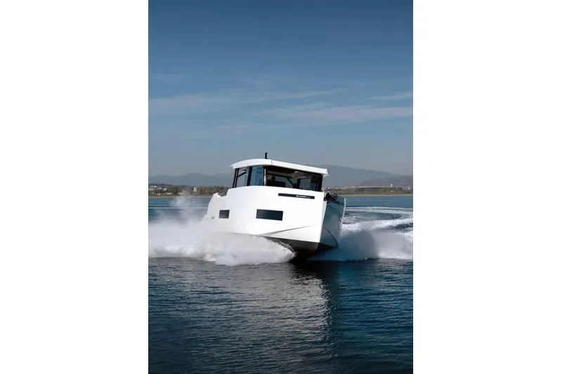  Yacht Photos Pics 2025 De Antonio Yachts D50 cruising on water, showcasing sleek design and performance.