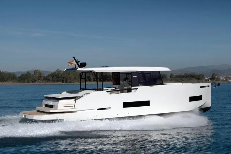  Yacht Photos Pics 2025 De Antonio Yachts D50 cruising on a serene blue lake.