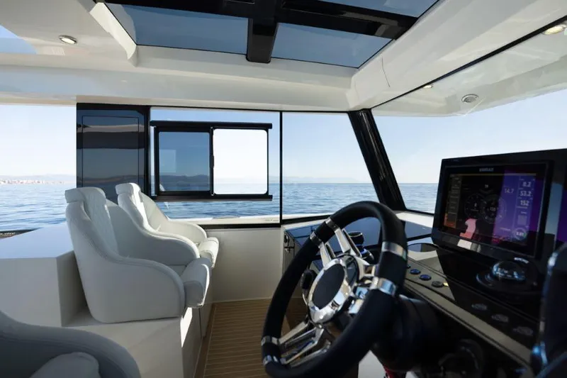  Yacht Photos Pics Interior view of 2025 De Antonio Yachts D50 cockpit with modern steering and navigation system.