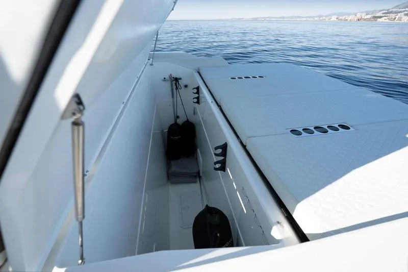  Yacht Photos Pics 2025 De Antonio Yachts D50 storage compartment with open hatch, showcasing sleek design on calm waters.