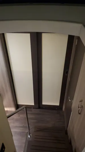 Regal 42 Xo Yacht Photos Pics Interior stairs of a 2022 Regal 42 XO yacht with modern sliding doors.