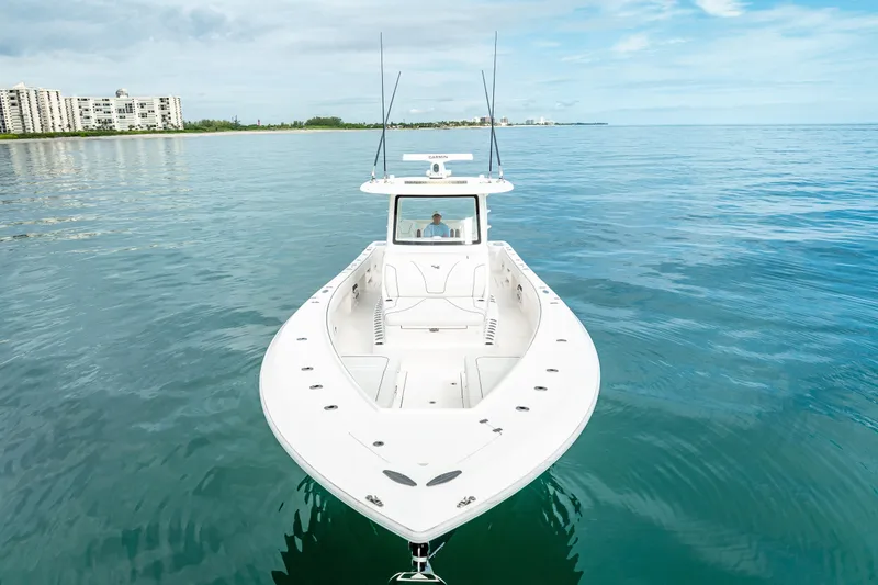  Yacht Photos Pics 2024 SeaVee 420Z boat on calm ocean near coastline, under clear sky.