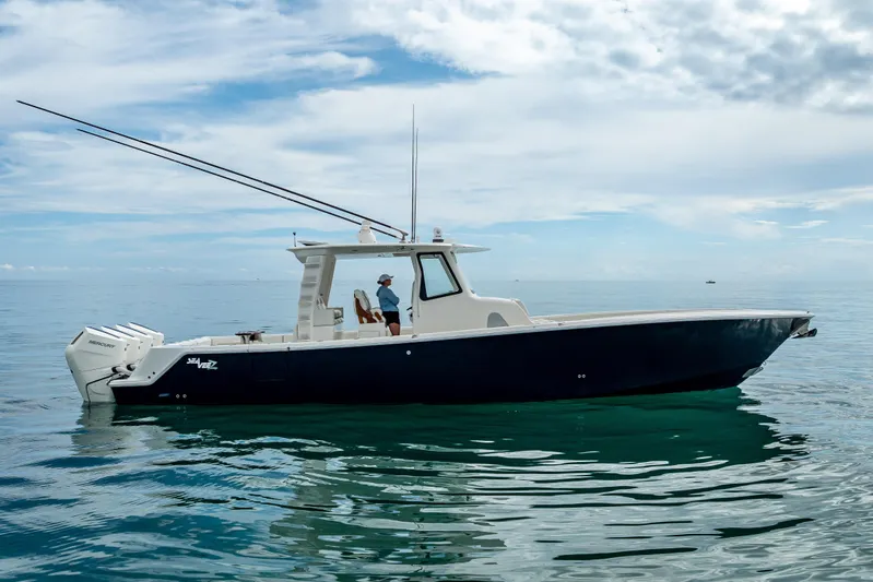  Yacht Photos Pics 2024 SeaVee 420Z boat on calm ocean waters under a cloudy sky.