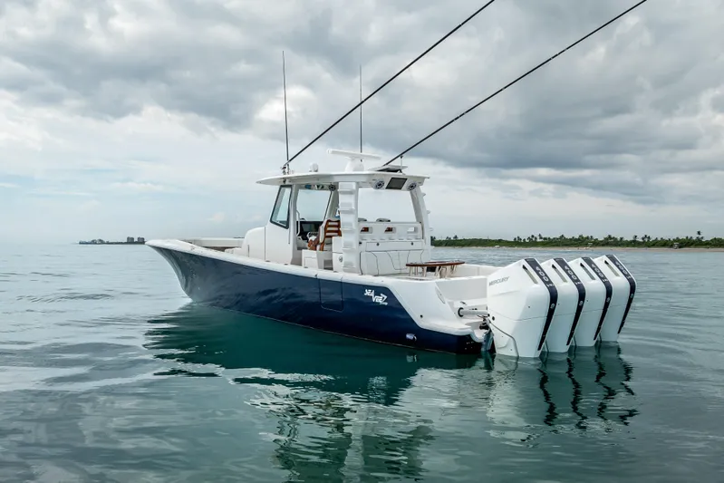  Yacht Photos Pics 2024 SeaVee 420Z boat with four outboard engines on calm water under cloudy sky.