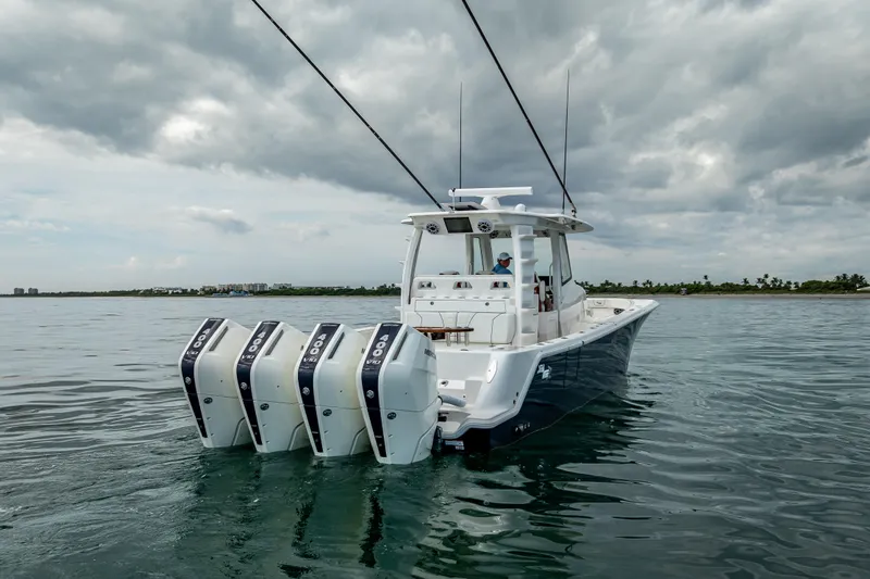  Yacht Photos Pics 2024 SeaVee 420Z boat with four engines on calm water under cloudy sky.