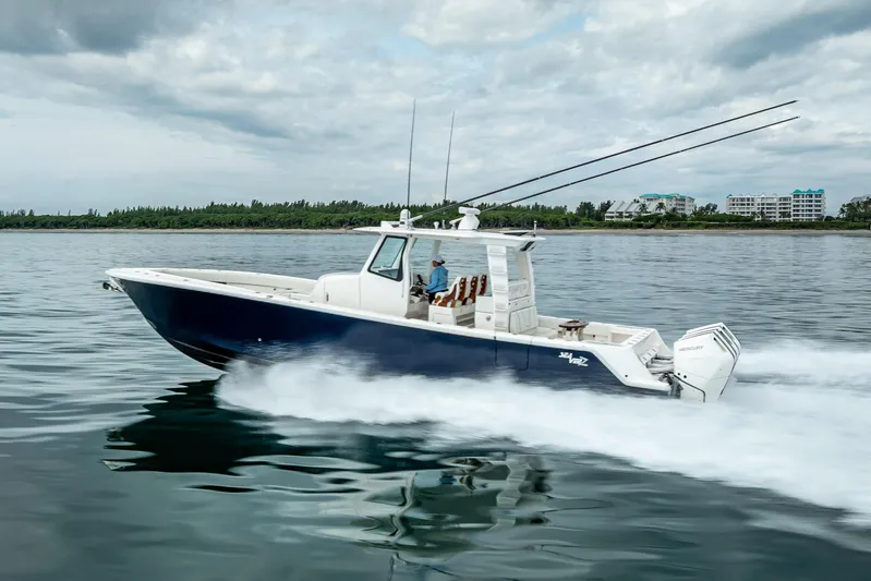  Yacht Photos Pics 2024 SeaVee 420Z boat cruising on calm waters under cloudy skies.
