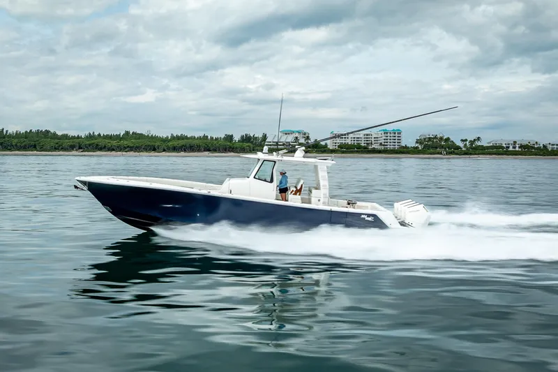  Yacht Photos Pics 2024 SeaVee 420Z boat cruising on calm waters under cloudy skies.