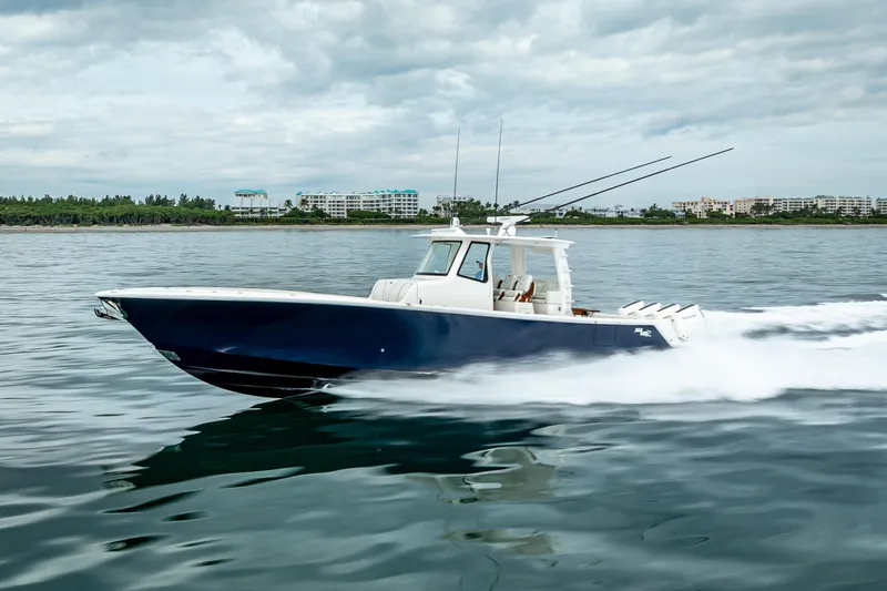  Yacht Photos Pics 2024 SeaVee 420Z boat cruising on calm waters under cloudy skies.