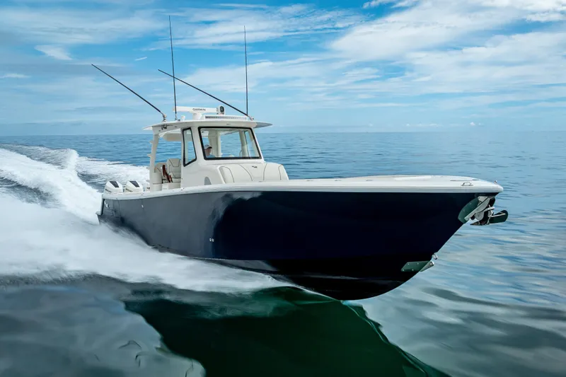  Yacht Photos Pics 2024 SeaVee 420Z boat cruising on calm ocean waters under a clear blue sky.