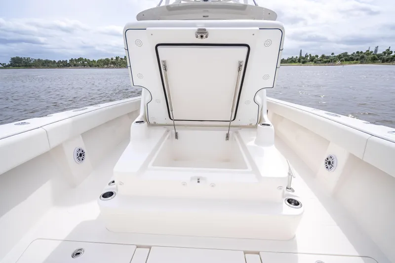  Yacht Photos Pics 2024 SeaVee 420Z boat with open storage compartment, white deck, and scenic water view.