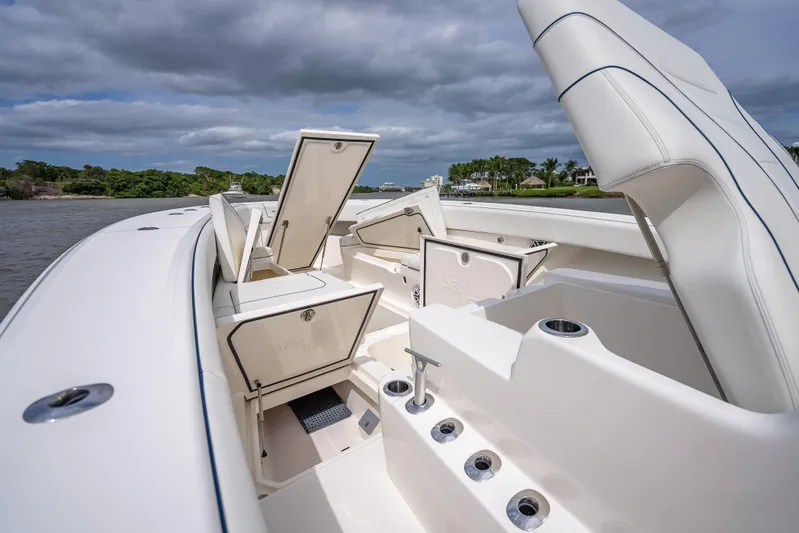  Yacht Photos Pics 2024 SeaVee 420Z boat interior with open storage compartments, sleek design, and scenic water backdrop.