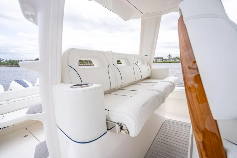  Yacht Photos Pics 2024 SeaVee 420Z boat interior with white cushioned seating and cup holder.