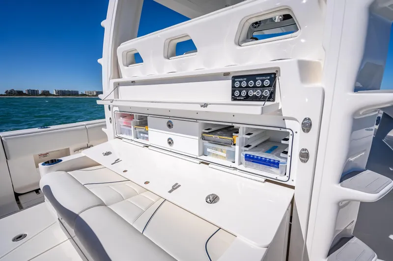  Yacht Photos Pics 2024 SeaVee 420Z boat interior with open storage compartments and control panel.