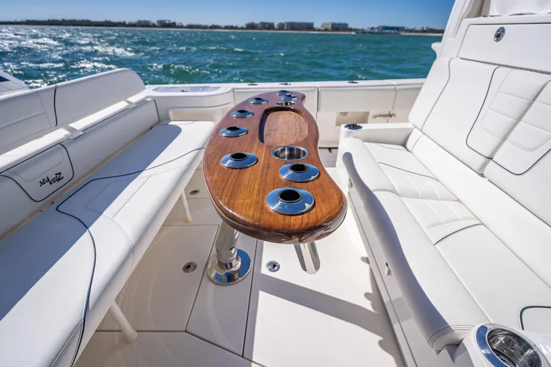 Yacht Photos Pics 2024 SeaVee 420Z boat interior with sleek seating and elegant wooden table.