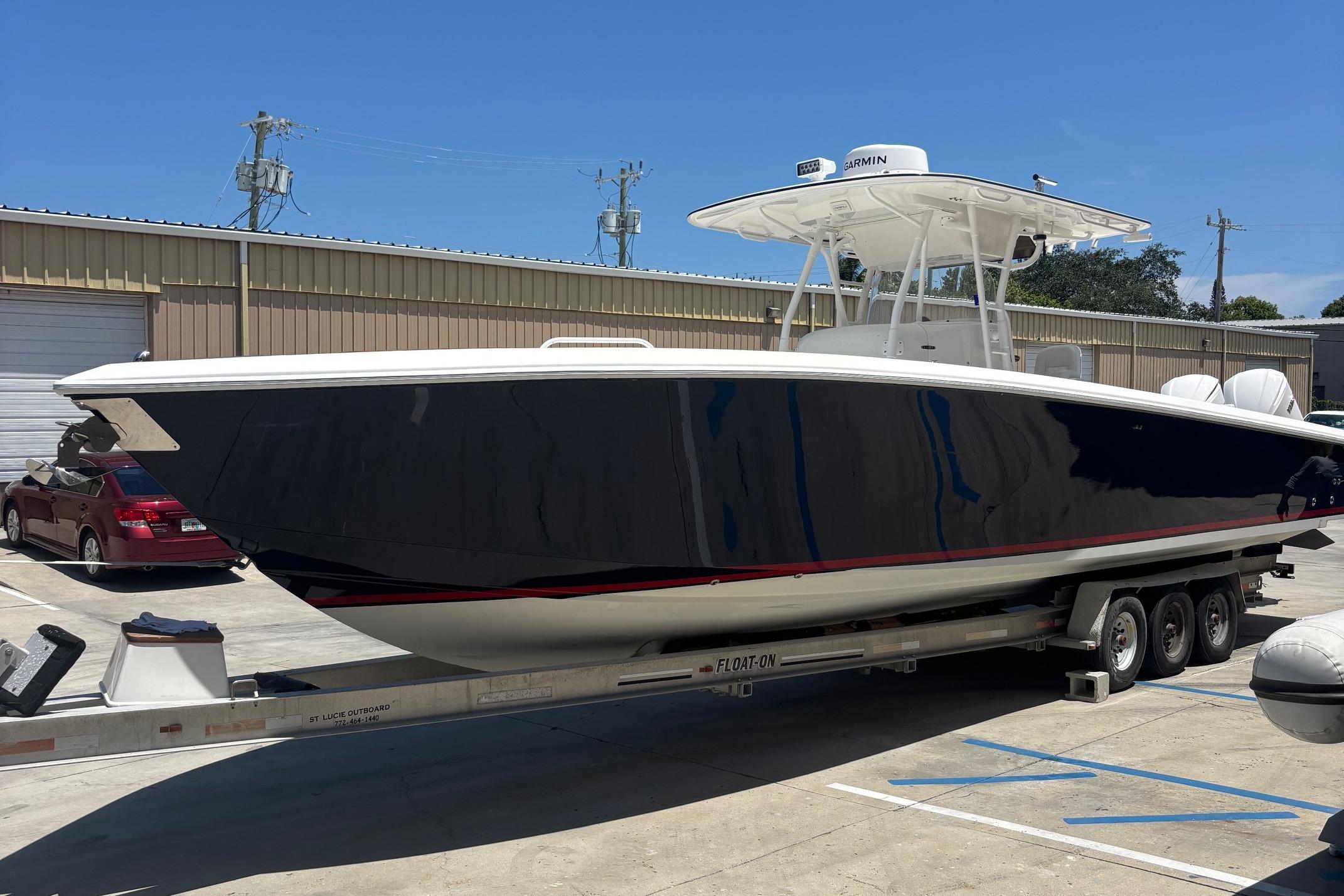 2005 Venture boat on trailer in sunny outdoor storage area.