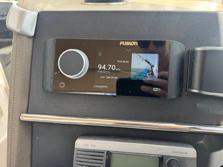  Yacht Photos Pics Fusion stereo system on a 2013 Regal 3200 Bowrider, displaying radio station 94.7 MHz.