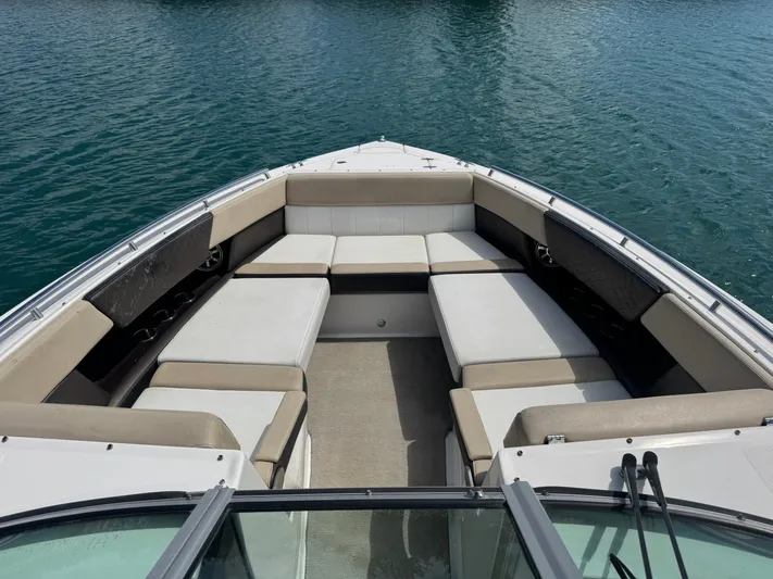  Yacht Photos Pics 2013 Regal 3200 Bowrider boat interior with spacious seating on calm water.