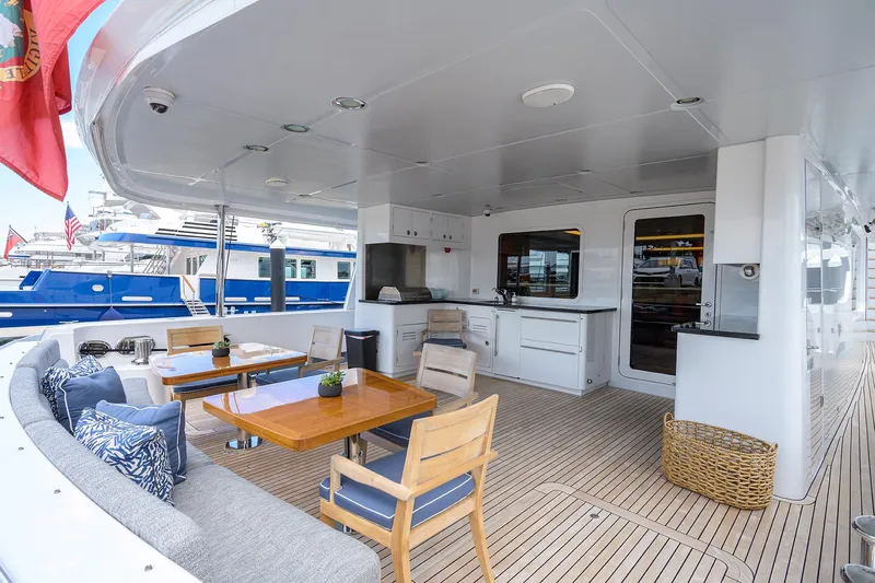 Lacey Kay Yacht Photos Pics Spacious outdoor deck of 2017 Nordhavn 96 yacht with seating and dining area.