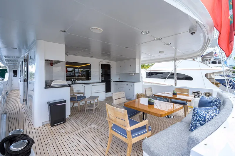 Lacey Kay Yacht Photos Pics Spacious deck area on a 2017 Nordhavn 96 yacht with seating and dining setup.