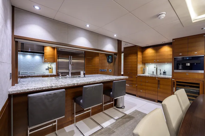 Lacey Kay Yacht Photos Pics Luxurious kitchen interior of 2017 Nordhavn 96 yacht with modern appliances and granite countertops.