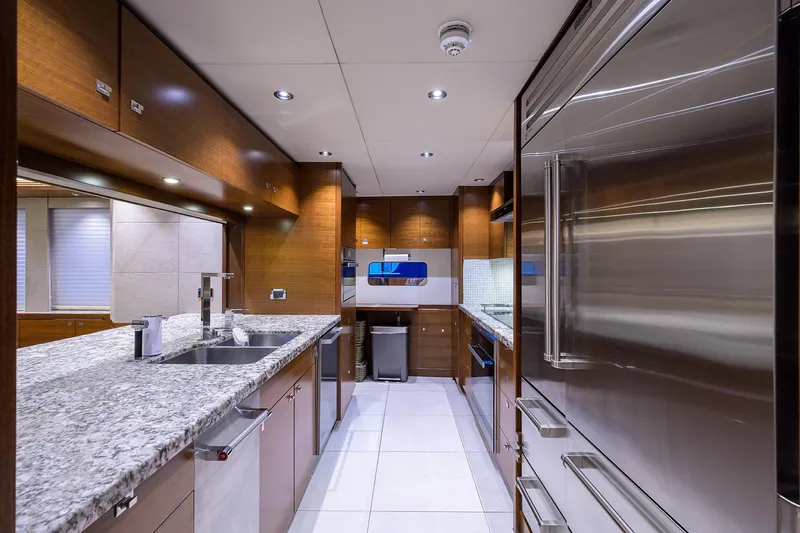 Lacey Kay Yacht Photos Pics Modern kitchen in a 2017 Nordhavn 96 yacht with granite countertops and stainless steel appliances.