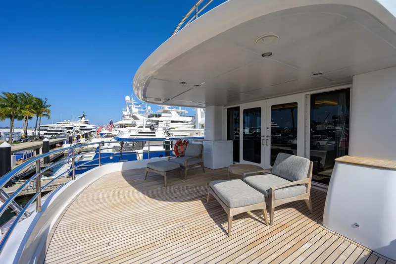 Lacey Kay Yacht Photos Pics Spacious deck of 2017 Nordhavn 96 yacht with lounge chairs and marina view.
