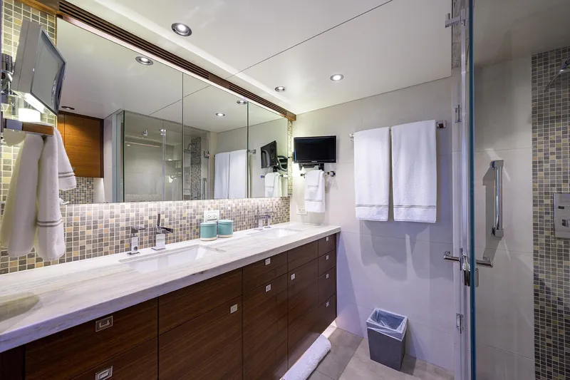 Lacey Kay Yacht Photos Pics Modern bathroom in a 2017 Nordhavn 96 yacht with double sinks and glass shower.