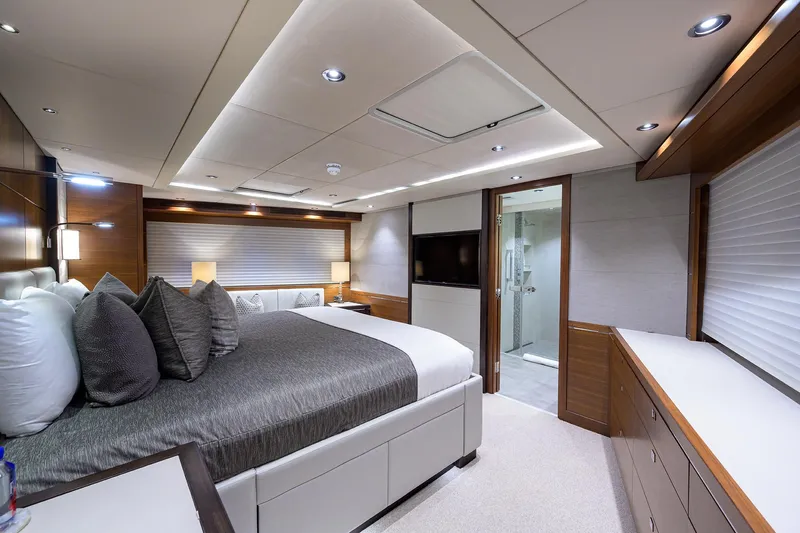 Lacey Kay Yacht Photos Pics Luxurious master bedroom on a 2017 Nordhavn 96 yacht with modern decor and ensuite bathroom.