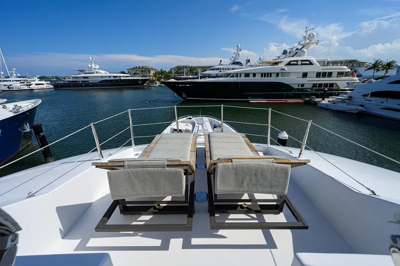 Lacey Kay Yacht Photos Pics Nordhavn 96 yacht 2017 model, docked with luxurious seating on deck, surrounded by other yachts.