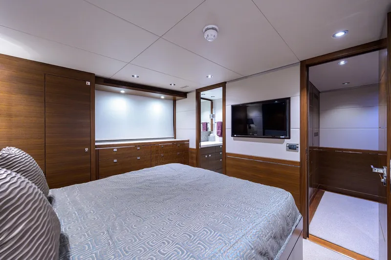 Lacey Kay Yacht Photos Pics Luxurious bedroom in 2017 Nordhavn 96 yacht with modern decor and flat-screen TV.