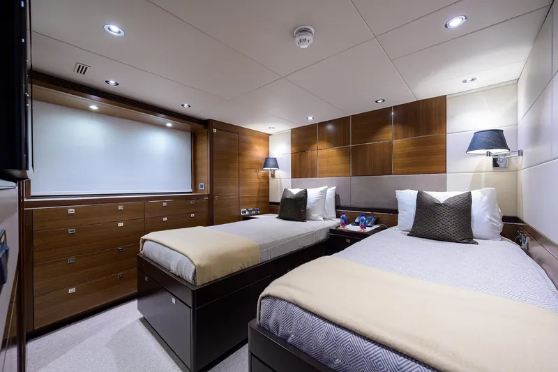 Lacey Kay Yacht Photos Pics Luxurious twin bedroom in a 2017 Nordhavn 96 yacht with modern wood paneling.