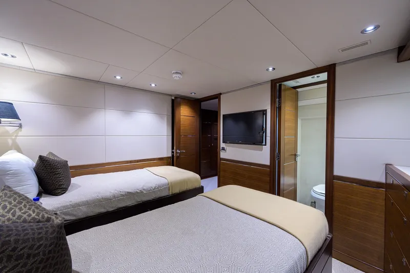 Lacey Kay Yacht Photos Pics Luxurious twin bedroom on 2017 Nordhavn 96 yacht with modern decor and ensuite bathroom.