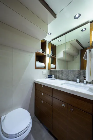 Lacey Kay Yacht Photos Pics Modern bathroom in a 2017 Nordhavn 96 yacht with wooden cabinetry and dual sinks.