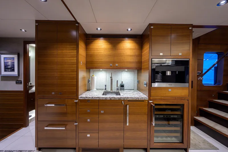 Lacey Kay Yacht Photos Pics Luxurious 2017 Nordhavn 96 yacht kitchen with modern wooden cabinetry and built-in appliances.