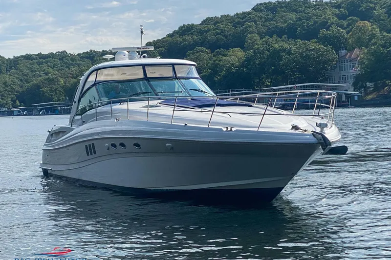  Yacht Photos Pics 2007 Sea Ray 52 Sundancer yacht on a serene lake with lush green shoreline.