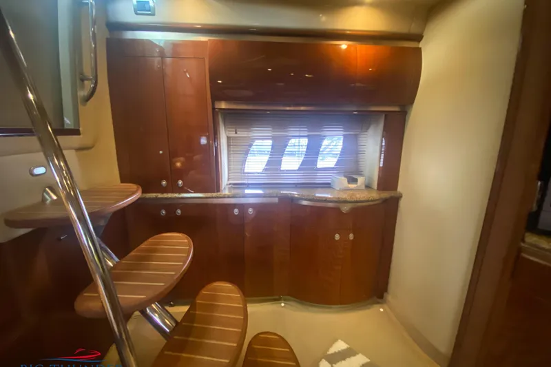  Yacht Photos Pics Luxurious interior of 2007 Sea Ray 52 Sundancer yacht with wooden cabinetry and staircase.