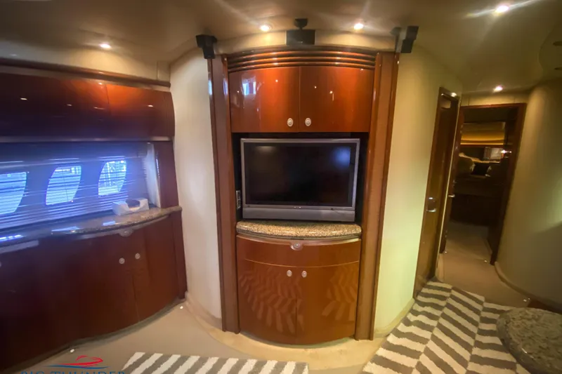  Yacht Photos Pics Luxurious interior of 2007 Sea Ray 52 Sundancer yacht with TV and wood cabinetry.