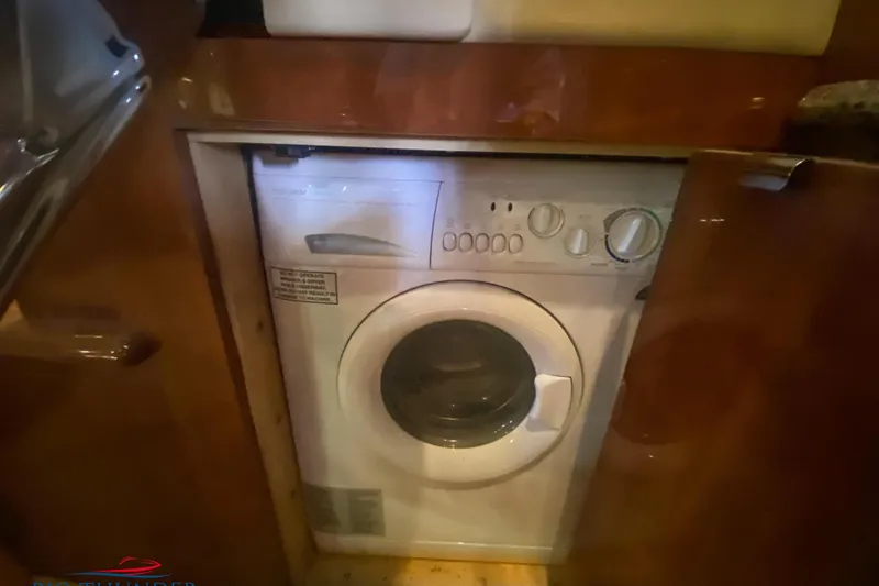  Yacht Photos Pics Washer-dryer unit inside 2007 Sea Ray 52 Sundancer yacht's wooden cabinet.