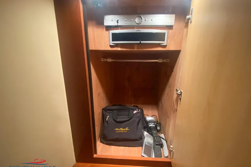  Yacht Photos Pics Interior cabinet of 2007 Sea Ray 52 Sundancer with electronics and storage bag.