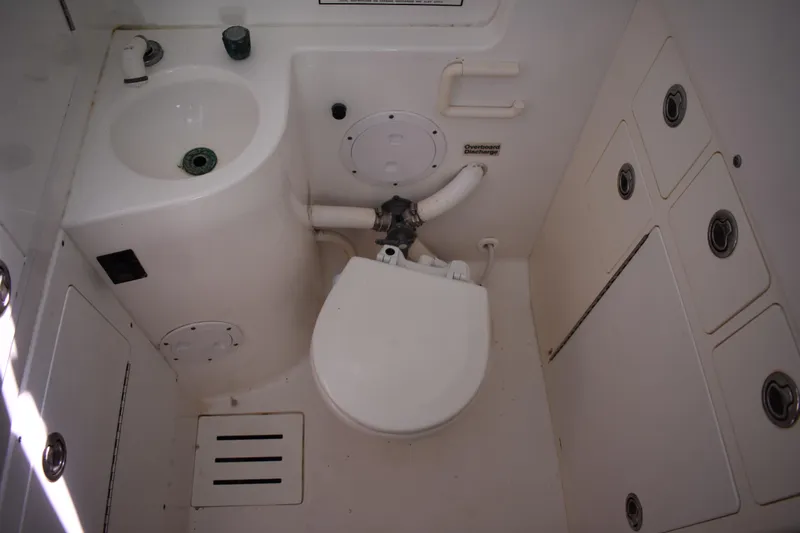  Yacht Photos Pics 2008 Regulator 32 Forward Seating boat bathroom with sink, toilet, and storage compartments.