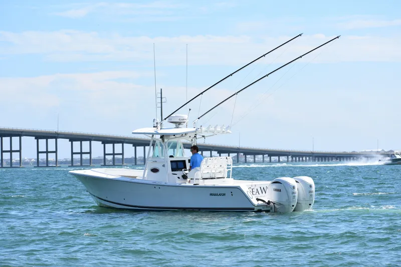  Yacht Photos Pics 2008 Regulator 32 Forward Seating boat on water near a bridge, clear sky.