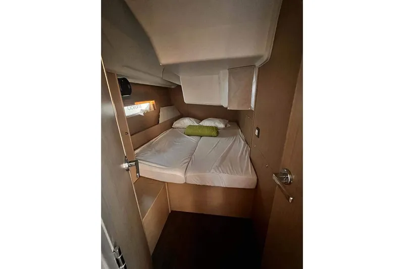  Yacht Photos Pics Cozy cabin interior of 2022 Beneteau Oceanis 40.1 yacht with bed and window.