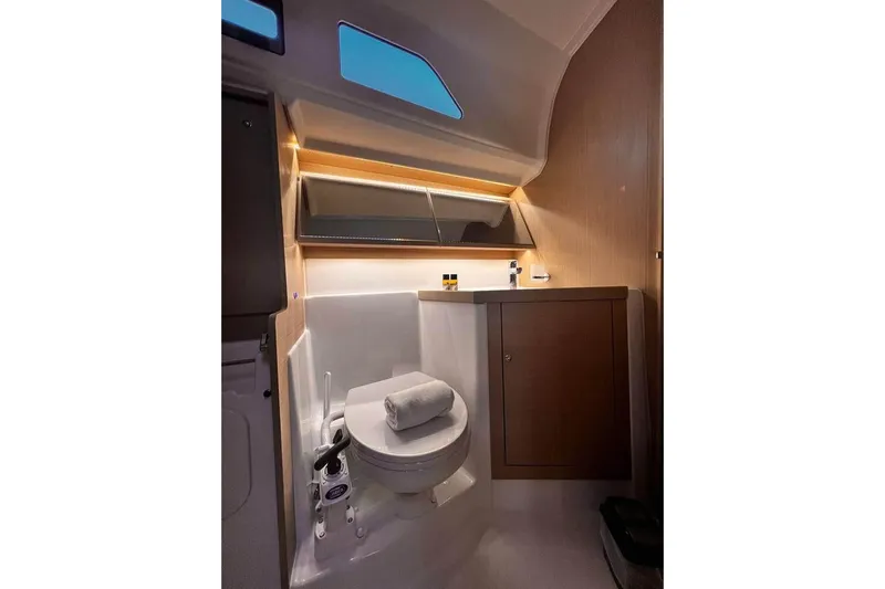  Yacht Photos Pics Beneteau Oceanis 40.1 2022 yacht bathroom with modern fixtures and wooden cabinetry.