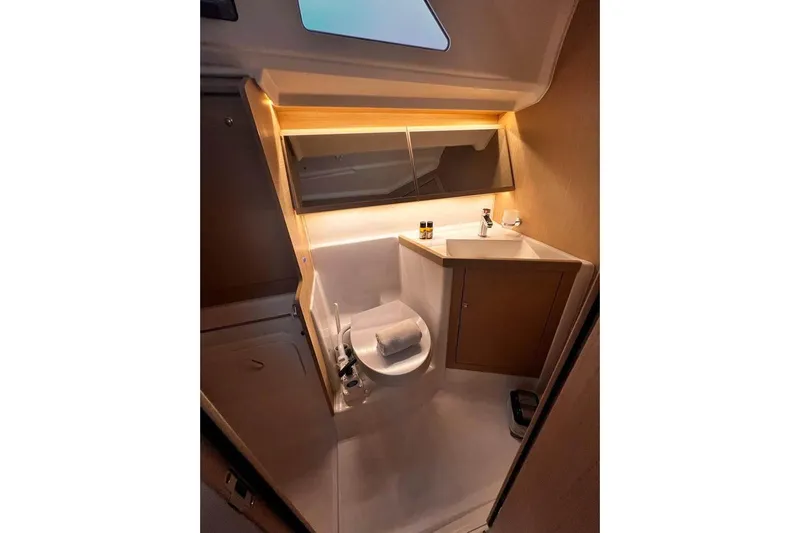  Yacht Photos Pics Modern bathroom in 2022 Beneteau Oceanis 40.1 yacht, featuring sleek design and compact amenities.